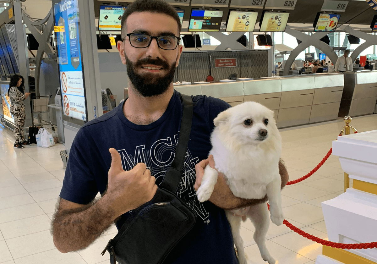 a happy dog owner at departure day at Suvarnabhumi airport thailand by Relo4Paws